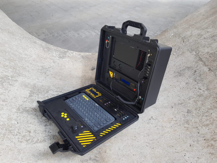 A military-looking cyberdeck with a built-in Geiger counter