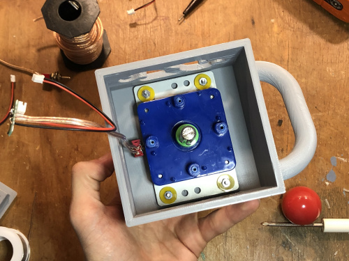 Joystick assembly secured to enclosure