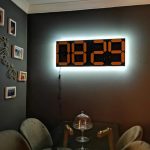 Electromechanical four-digit seven-segment clock displays the time silently