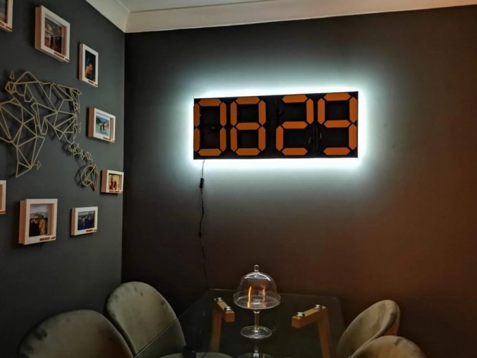 Electromechanical four-digit seven-segment clock displays the time silently