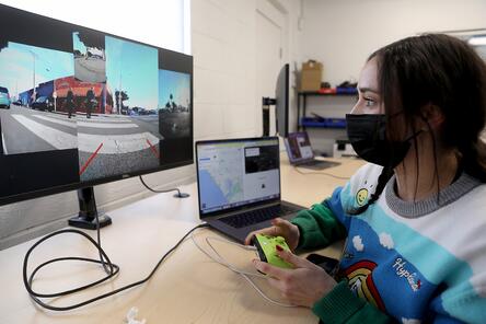 Person using a remote driver in front of a computer screen