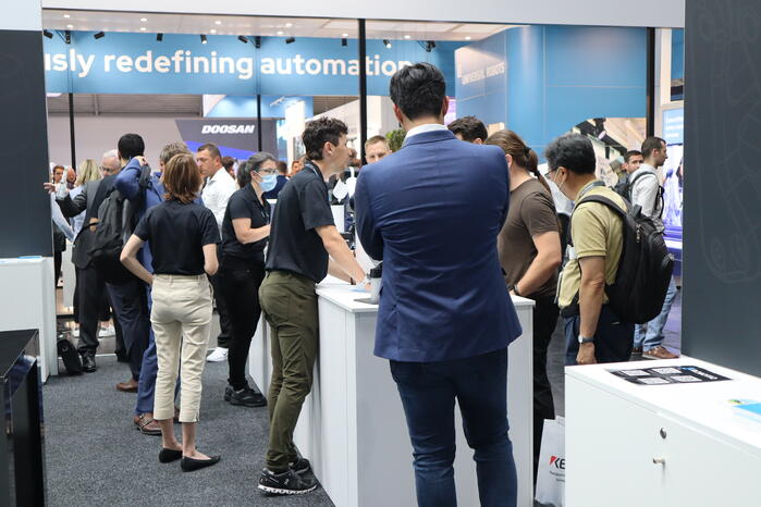 People discussing automation at Automatica 2022