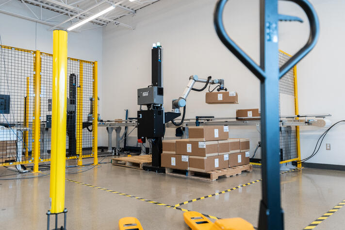 Robotic palletizer placing boxes on a pallet