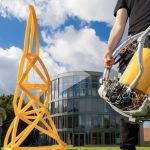 This machine automatically fabricates inflatable truss structures