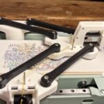 This DIY pen plotter has delta kinematics and a tool changer